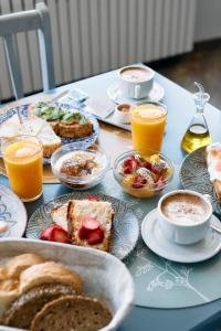 a table topped with plates of breakfast foods and drinks at Hotel Casa Cauma in Albarracín