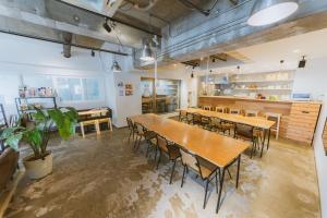 a dining room with wooden tables and chairs at The Stay Sapporo in Sapporo