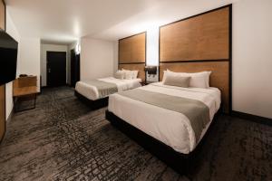 Cama ou camas em um quarto em AX Hotel