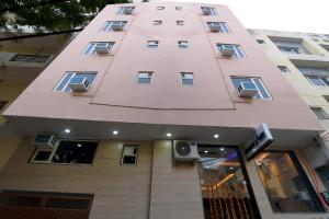 a tall pink building with a speaker on it at Hotel Urban Tree At Delhi Airport in New Delhi