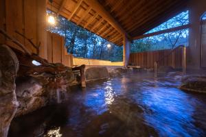 una piscina de agua en un edificio con una casa en Ryokan Nushiya, en Gotsu