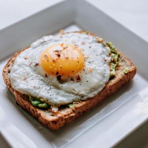 an egg on a piece of bread in a styrofoam box at Hotel Urban Tree At Delhi Airport in New Delhi