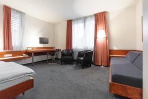 een hotelkamer met een bed en een bureau bij Hotel Böll Essen in Essen