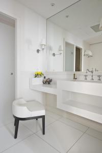 a white bathroom with a sink and a stool at Villa Clarisse & Spa by Olivier Claire in Saint-Martin-de-Ré