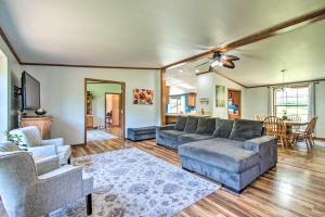 a living room with a couch and chairs and a table at Sunny Wisconsin Dells Apartment with Deck and Fire Pit in Wisconsin Dells