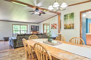 a dining room and living room with a table and chairs at Sunny Wisconsin Dells Apartment with Deck and Fire Pit in Wisconsin Dells