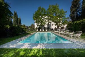 a swimming pool in the yard of a house at Villa Neroli in Florence