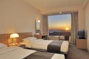 A bed or beds in a room at Kushiro Prince Hotel