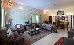 a living room with couches and a dining room at Madhav's Mallet in Jaipur