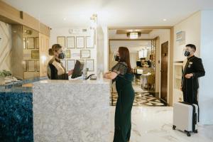 a woman and a man standing in front of a counter at El Bien Hotel Tagaytay in Tagaytay