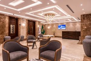 a lobby with chairs and a chandelier at idles By Staytion Serviced Apartments in Jeddah