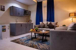 a living room with a couch and a table at idles By Staytion Serviced Apartments in Jeddah