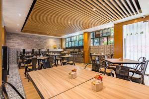 a restaurant with wooden tables and chairs and windows at Kali Ciudadela Mexico City in Mexico City