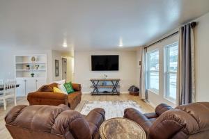 a living room with two couches and a flat screen tv at Green Bay Stay in Green Bay