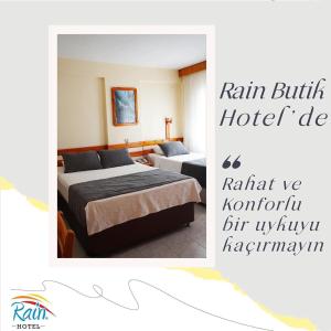 A bed or beds in a room at Rain Hotel