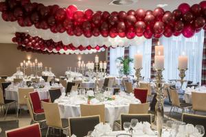 a banquet hall with white tables and red balloons at Holiday Inn Düsseldorf-Neuss, ein IHG Hotel in Neuss