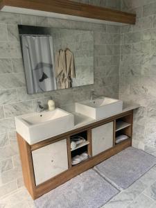 a bathroom with two sinks and a mirror at HS68-apartment in Maastricht