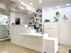 a white room with a counter with machines on it at Hotel Flats Friends Mar Blau in Benidorm