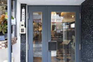 a front door of a store with a blue door at Cafe & Guest House Nagonoya in Nagoya