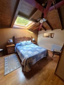 a bedroom with a bed and a skylight at Hotel La Balsa in Cangas de Onís