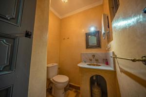 a small bathroom with a toilet and a sink at Riad Azawan in Marrakesh