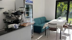 a kitchen with a blue couch and a table with chairs at Vila Lazri in Shëngjin