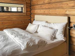 un letto con cuscini bianchi sopra di Holiday home Moen a Moen i Målselv