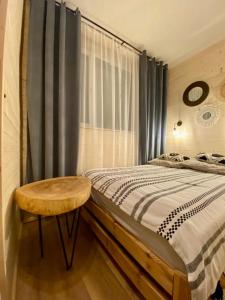 a bedroom with a bed and a wooden table at Połoninka in Ustrzyki Górne