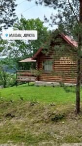 a log cabin with a bench in front of it at Nice House in Maidan Village