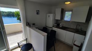 a small kitchen with a view of the water at Apartment Iva&Andro in Koločep