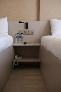 a room with two beds and a table with water bottles at Cinas Hotel in Eskisehir