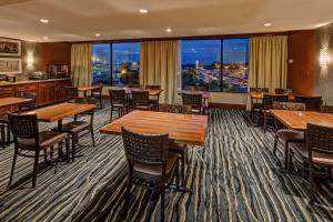 a restaurant with tables and chairs and a large window at Hilton Knoxville Airport in Alcoa