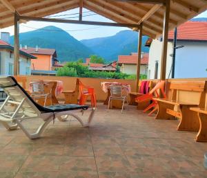 a patio with chairs and a table and a bench at ViBo Guesthouse in Sapareva Banya