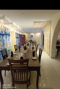 a long dining room with a long table and chairs at Hotel Grand Home in Murree