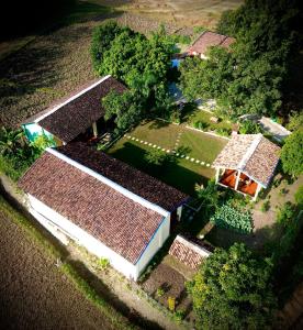 an overhead view of a group of houses with trees at Bardia Eco Friendly Homestay in Bhurkīā