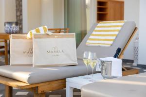 a table with a mattress and a glass of wine at Hotel Mamela in Capri