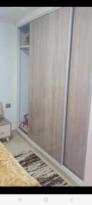 a closet with a sliding glass door in a room at Residence djerba 4 in Houmt Souk