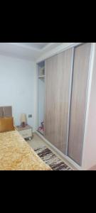 a bedroom with a large closet and a bed at Residence djerba 4 in Houmt Souk