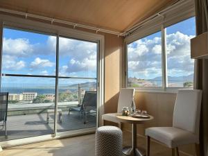 a room with a table and chairs and a large window at Hotel Revellata & Spa in Calvi