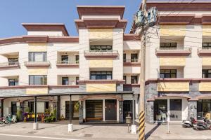 an apartment building on the corner of a street at Mini House B&B in Luodong