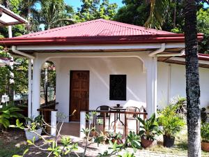 a small white house with a red roof at Private 1-BR Bungalow #3 in Moalboal