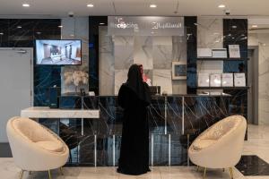 a woman stands in front of a counter in a store at Abela Al Hamra - Palestine Street in Jeddah