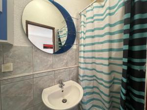 a bathroom with a sink and a mirror at Melek in Medulin