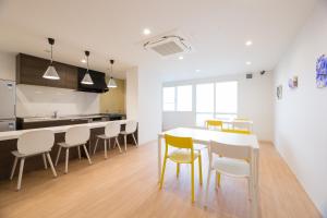 a kitchen and dining room with a table and chairs at あやきちゲストハウス in Daikōchō