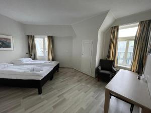 Кровать или кровати в номере P-Hotels Oslo