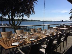 a long wooden table with chairs and wine glasses at Hotel Christiansminde in Svendborg