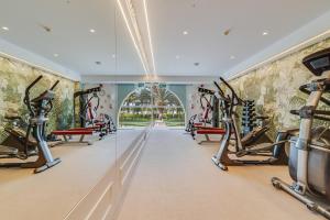 un gimnasio con cintas de correr y máquinas elípticas en Palm Oasis Maspalomas en Maspalomas