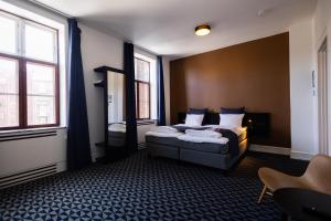 Кровать или кровати в номере Milling Hotel Ritz Aarhus City