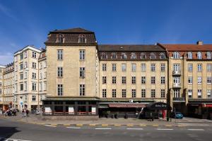 un gran edificio de ladrillo en la esquina de una calle en Milling Hotel Ritz Aarhus City en Aarhus