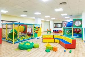 una sala de juegos para niños con juguetes y equipo de juegos en Alexandre Hotel La Siesta, en Playa de las Américas